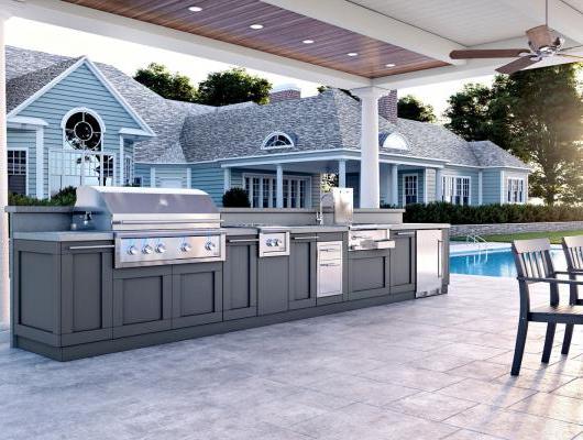 Outdoor kitchen in backyard next to pool